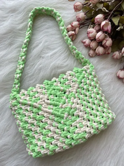 This shoulder bag features a fresh look with its neon green and off-white checkered pattern. The design is lightweight and the strap is knotted for extra durability.