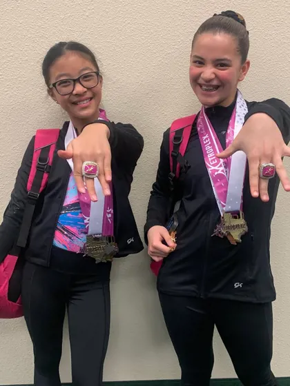 Showing off the rings! Two of our individual all-around winners from the Metroplex Challenge with their champion rings.