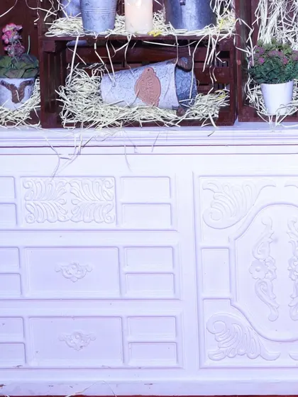 A close-up of our versatile white counters, here decorated with rustic elements like galvanized metal buckets and hay. These counters can be styled to fit any theme.