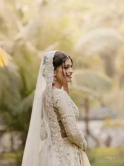 A soft and dreamy profile shot of the bride, with a beautifully blurred background that makes her the sole focus.