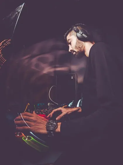 A fisheye lens captures me deep in concentration at the mixer, giving a sense of the immersive, high-energy environment of the DJ booth.