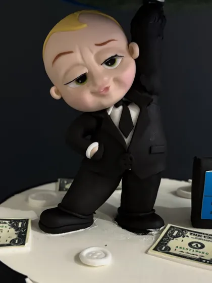 The details make the cake! A close-up of the main Boss Baby figure, showing his signature suit, briefcase, and confident expression.