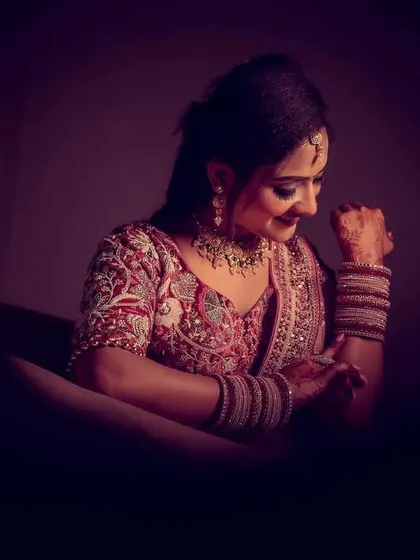 A creative and dark-toned portrait of the bride-to-be, capturing a gentle smile.