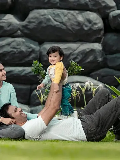 Playtime with dad is always the best. We captured this sweet, candid moment of a father lifting his smiling son during a relaxed family photoshoot on our lawn.