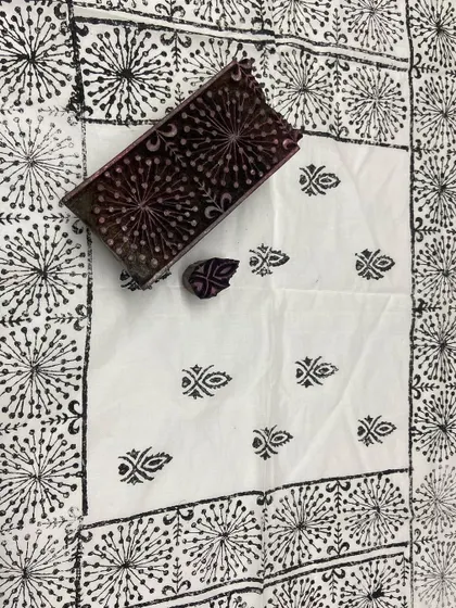A finished piece of block-printed fabric with a central design and decorative border.
