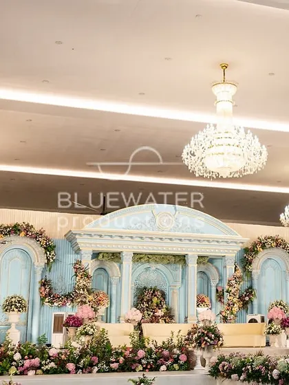 The 'Blue Palace' stage seen from a slight angle, emphasizing the depth and layers of the structure, with crystal chandeliers adding a touch of sparkle.