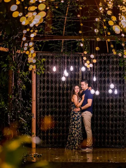 A wide-angle view of the magical archway with hanging bulbs. This shot captures the entire enchanting scene, making the couple's portrait feel grand and cinematic.