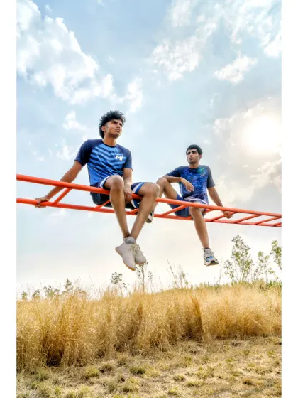 A lifestyle shot from the Mumbai Indians shoot, showing two models in a natural, outdoor setting. This demonstrates our versatility in creating authentic, relatable moments for a brand's apparel line.
