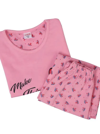 A folded pink pajama set for kids, shot from an angle. This type of product photography helps showcase the item in a compact and neat way.