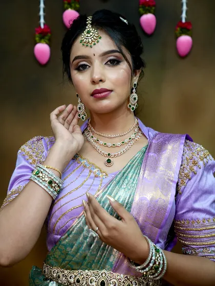 This pose highlights the matching earrings and bangles, showing the completeness of the set.