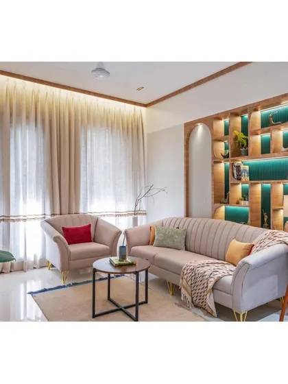 The full living room setup, showcasing the interplay of light from the large windows and the warm, ambient lighting from the ceiling. The space feels open, airy, and connected to the outdoors.