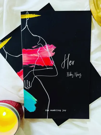 This is my debut poetry book, 'HER'. It's a collection of poems written for the feminine spirit that resides in all of us. Holding this book is a reminder that our words and stories deserve to be shared and cherished.