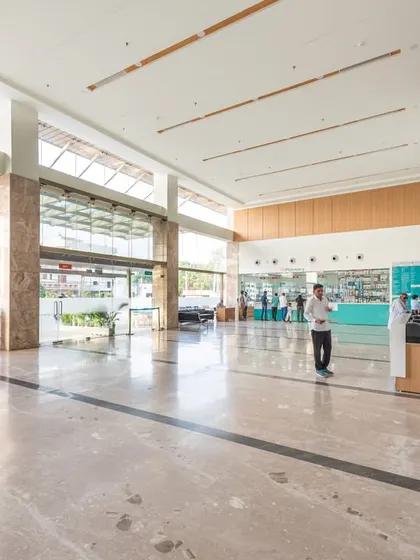 The entrance lobby at Sarvesh Health City is flooded with natural light from floor-to-ceiling windows. This bright and airy space creates a positive first impression and helps to ease the anxiety often associated with hospital visits.