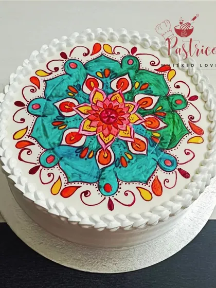 A top-down view of the beautiful hand-painted Mandala cake, showing the vibrant colours and intricate patterns.
