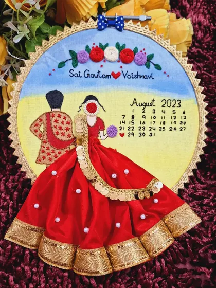 Another beautiful example of a custom wedding embroidery hoop, featuring a couple in their wedding attire and a calendar marking their special day.