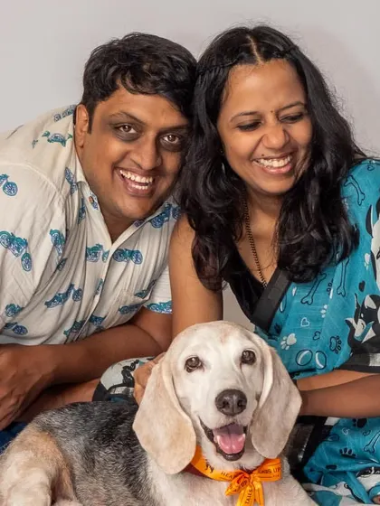A family photo filled with smiles and a very happy beagle. These are the heartwarming moments that make a house a home, captured during a relaxed studio session.