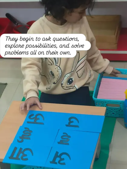 As they work with the materials, children begin to ask questions, explore possibilities, and solve problems all on their own. Here, a child works with Hindi language sandpaper cards, developing literacy skills.