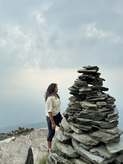 A moment of quiet contemplation by a stack of stones on the Triund trek. The mountains have a way of putting everything into perspective.