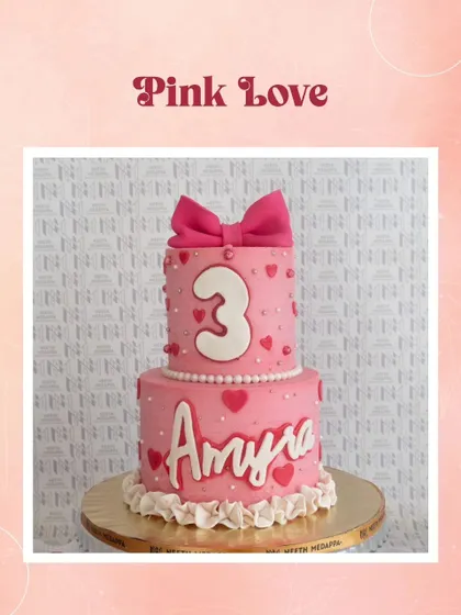 An example of "Pink Love," this two-tiered cake with a big bow is perfect for a sweet and girly celebration.
