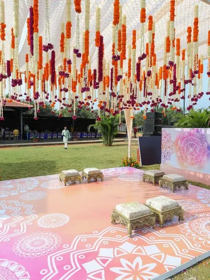 The complete setup for Sonam's purple-themed Haldi ceremony. We used canopies with purple and orange drapes and a custom-printed floor to bring her vision to life.