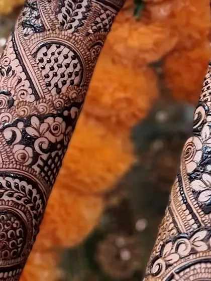A close-up of the detailed patterns on the arms, featuring reverse-fill floral motifs that create a beautiful negative space effect.