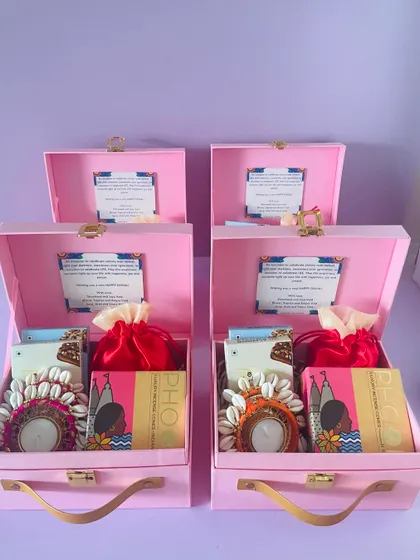 We ensure every hamper in a bulk order is consistently packed, as seen with these pink suitcase boxes featuring custom message cards for a corporate client.