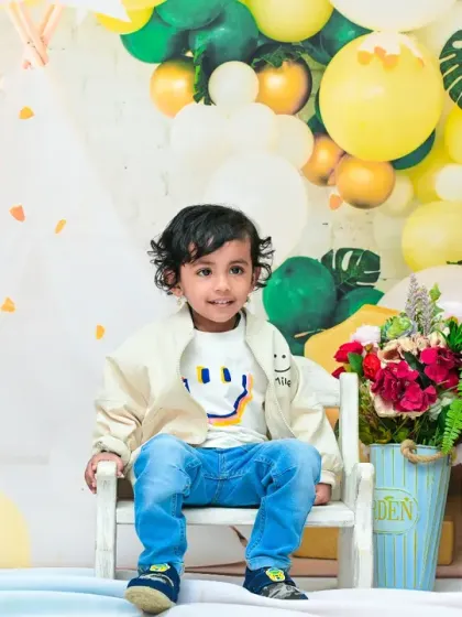 This toddler looks so proud sitting in his chair for his second birthday portrait. It's amazing to see how much they've grown since their first birthday.