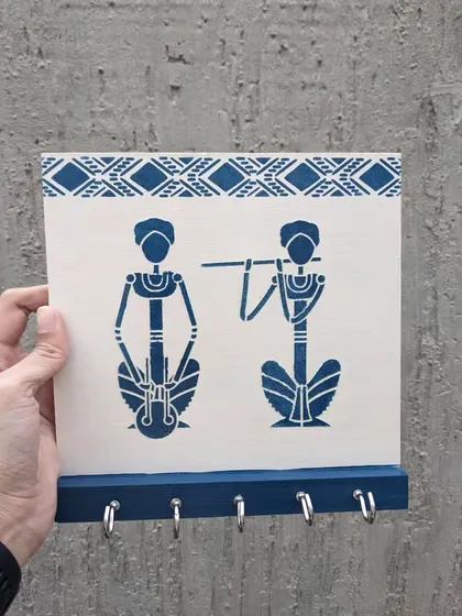 A key holder featuring a traditional Warli art design, adding an ethnic touch to your wall.
