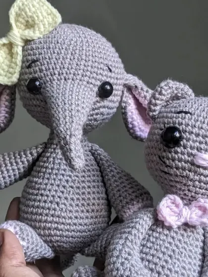 A pair of friends, a grey elephant and a grey cat, ready for an adventure together.