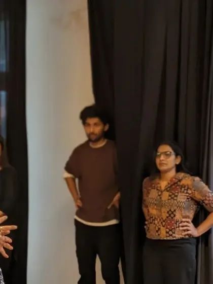 An instructor leads a session on intuitive body movement, guiding participants to listen to their bodies and move in ways that feel authentic.