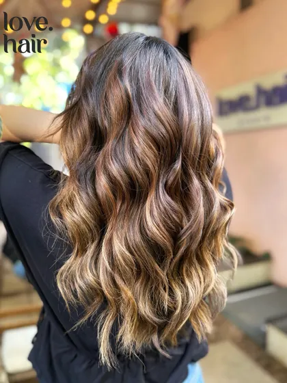 A detailed shot of the sun-kissed balayage, showing the placement of the lighter pieces.