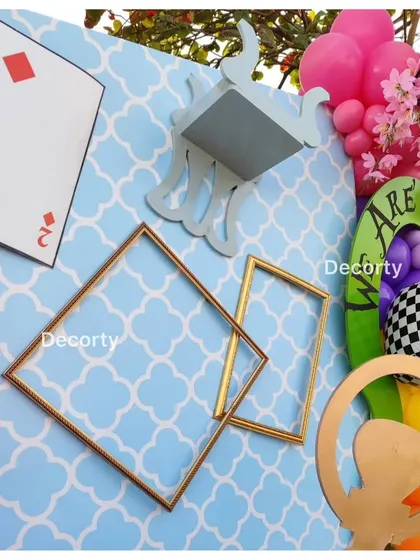 A close-up of the whimsical decor elements, including floating frames and playing cards.