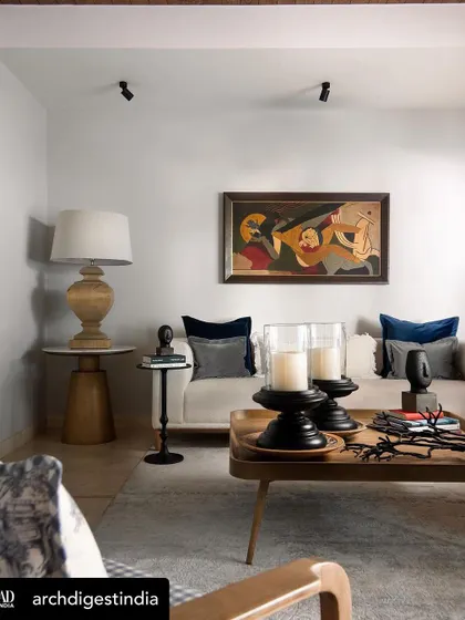 Another angle of the living room with the MF Husain painting, showing the relationship between the art, the furniture, and the architectural elements of the space.