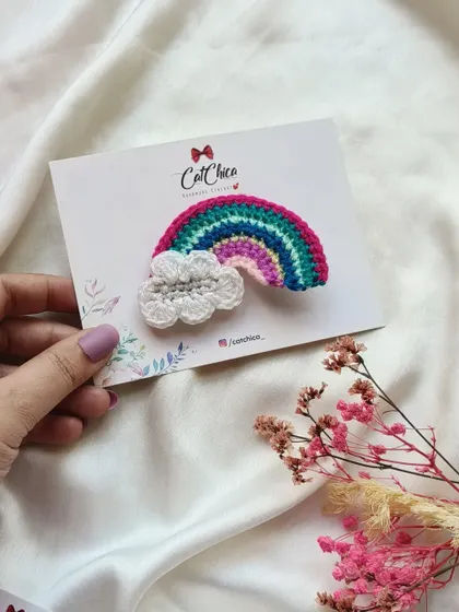 A beautiful crochet rainbow and cloud clip, perfect for adding a touch of magic to your hairstyle.