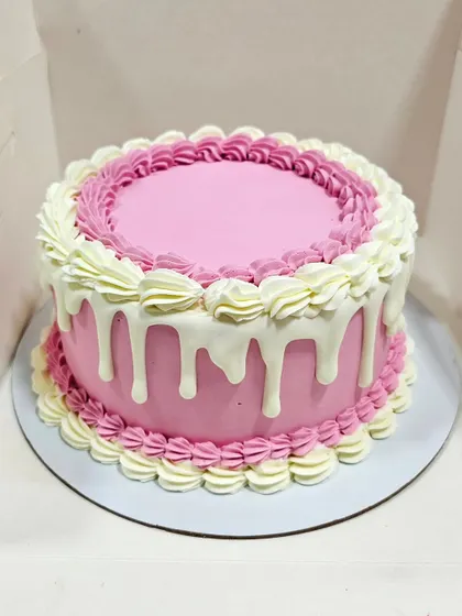 A classic pink drip cake with two-tone piped borders. This is a great introductory project for learning basic buttercream smoothing and simple, effective piping skills.