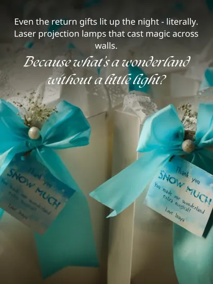 Thoughtful return gifts for the Mystic Wonderland party. Laser projection lamps were wrapped with blue ribbons and a tag that reads, "Thank you SNOW MUCH for making our wonderland extra magical."