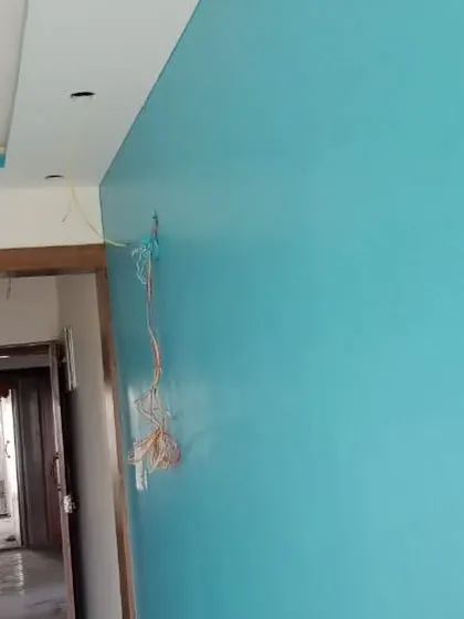 A striking turquoise blue wall adds a pop of color to this room. We ensure a smooth, even finish for both neutral and vibrant color choices.