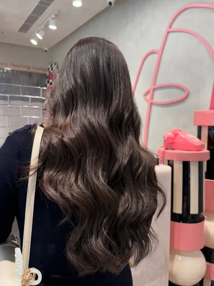 A beautiful ash brown that gives off a whole new vibe. The color is cool, deep, and styled into classic, glossy waves.