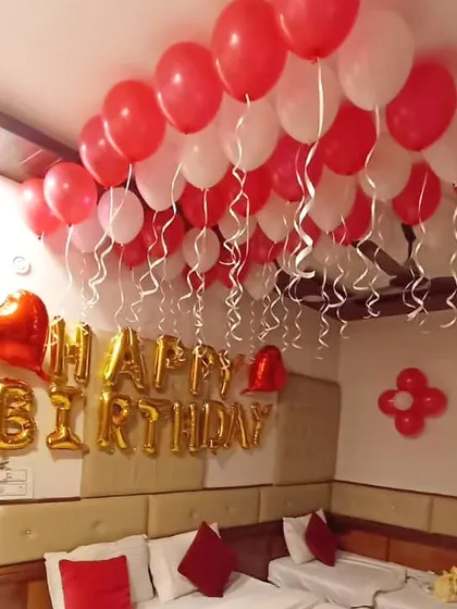 Another angle of the room setup, showing the heart-shaped foil balloons next to the birthday banner.