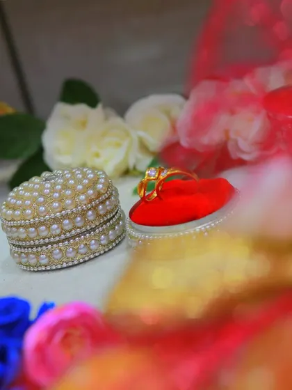 An artistic, close-up shot of an engagement ring in its decorative box.