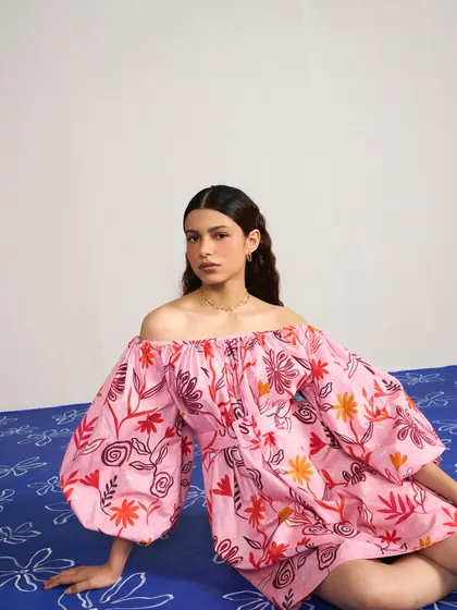Styling and direction for Joskai Studio, featuring a vibrant pink off-the-shoulder dress. The custom-painted floor adds a playful and artistic element to the shoot.