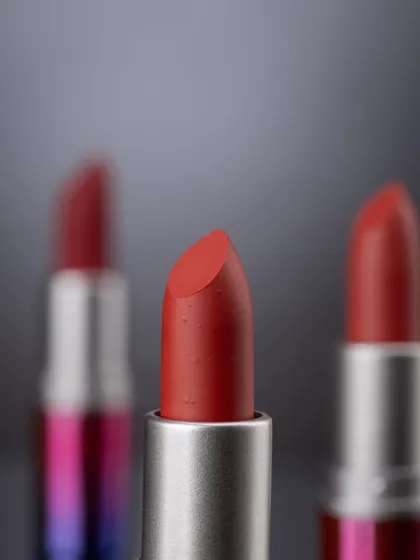 A detailed macro shot with a shallow depth of field, focusing on the texture of one lipstick bullet while others blur into the background. This creates a sense of depth and artistry.