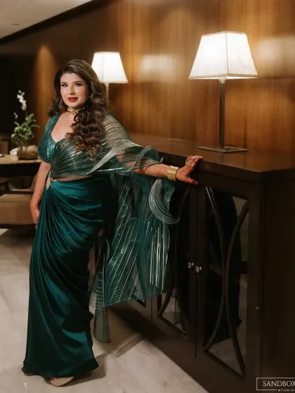 An elegant portrait of the bride. The classic interior and soft lighting provide a beautiful backdrop, highlighting her sophisticated reception look.