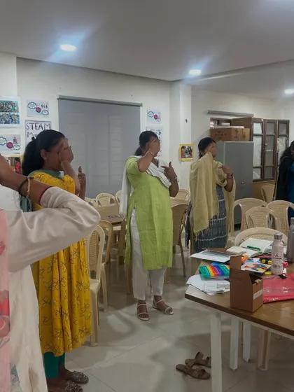 A different angle of the mindfulness exercise, showing how the entire group participates. Creating a shared, calming experience helps build a strong sense of community among educators.
