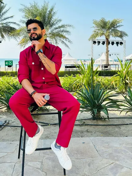 A bold, monochrome red outfit for a beach event. This look is all about making a statement and standing out.