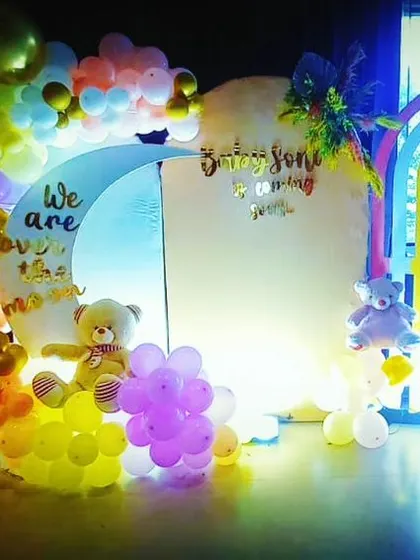 An "Over the Moon" theme decoration for a baby shower. We used pastel balloons, a moon-shaped backdrop, and teddy bear props to create a dreamy and whimsical atmosphere.