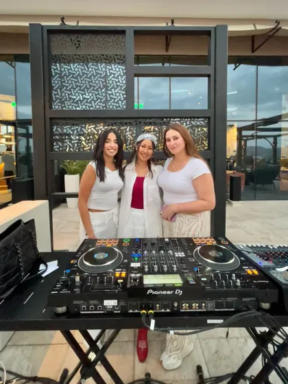 Another group photo behind the decks, capturing the good vibes and memories created.