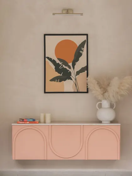 This custom-designed pink credenza with arched door details adds a soft, sculptural element to the Brigade Valencia office.