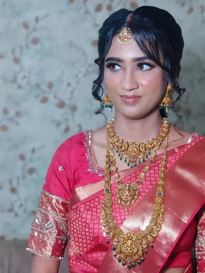 Ankita's wedding look in a stunning red Kanjeevaram saree, with soft makeup and a classic bridal updo.