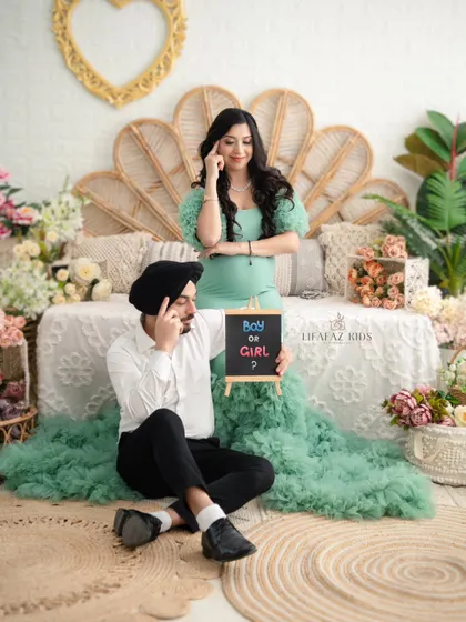 A fun and playful moment from their session. The couple wonders "Boy or Girl?" with a chalkboard prop, adding a touch of lighthearted fun to their maternity portraits.